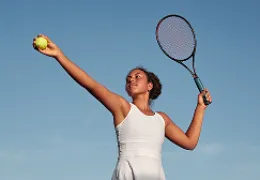 woman in mid-tennis swing