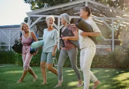  women holding yoga mats